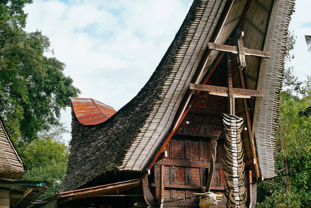 Front view of a traditional Tongkonan house in Toraja with symbolic carvings