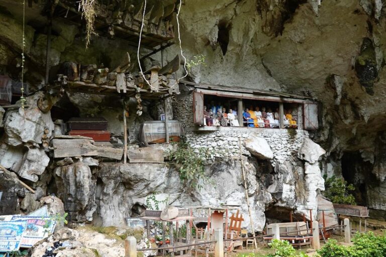 Londa Toraja cliff burial site with wooden Tau-Tau statues overlooking the valley